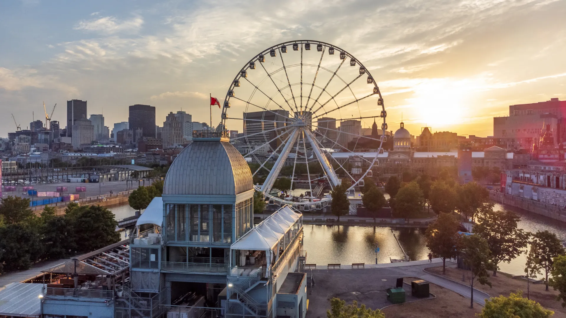 Old Port of Montreal with La Grande Roue ferris wheel and the downtown skyline at sunset
