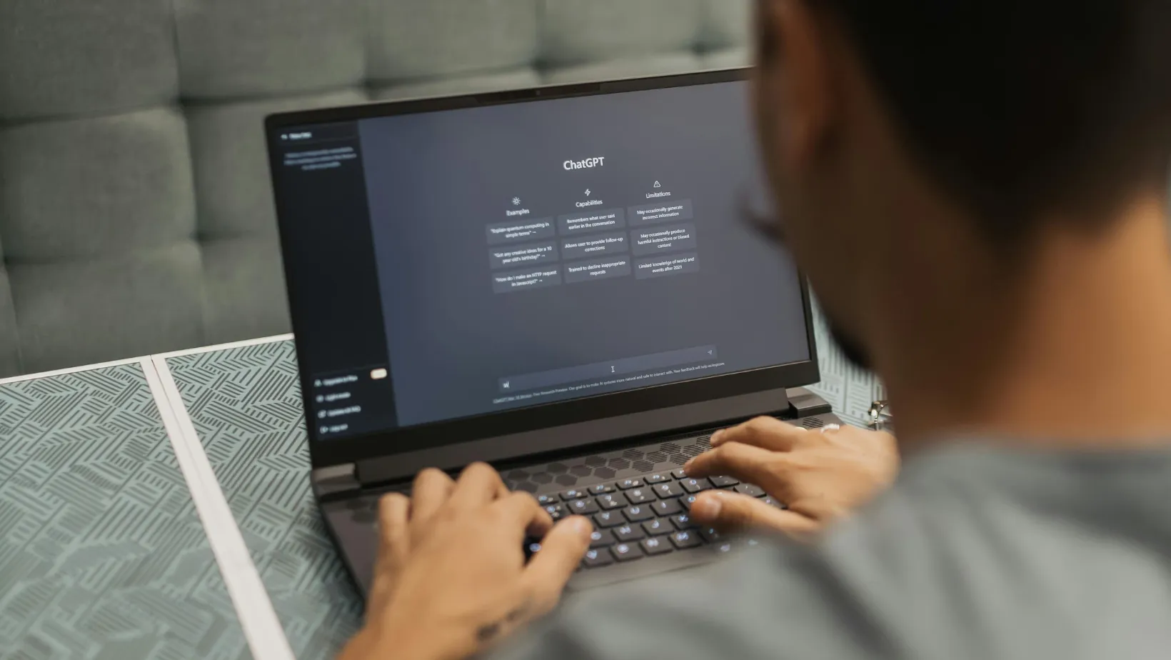 Man typing on a laptop with the ChatGPT start screen open