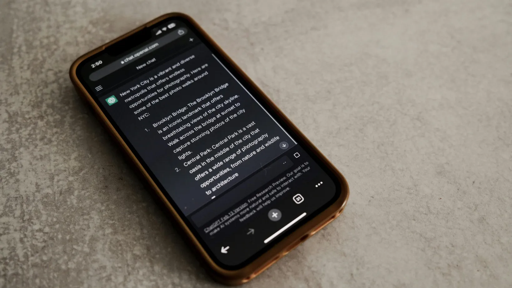 Phone on a stone table showing a ChatGPT conversation