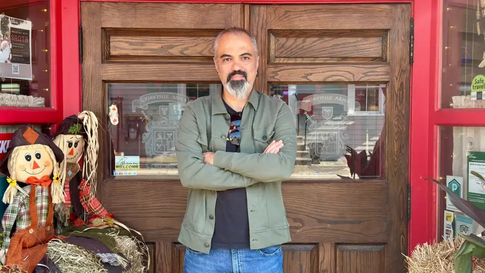Ahmet Dogan, ChatGPT ads consultant, standing with arms crossed outside the Unionville Arms in Unionville, Markham