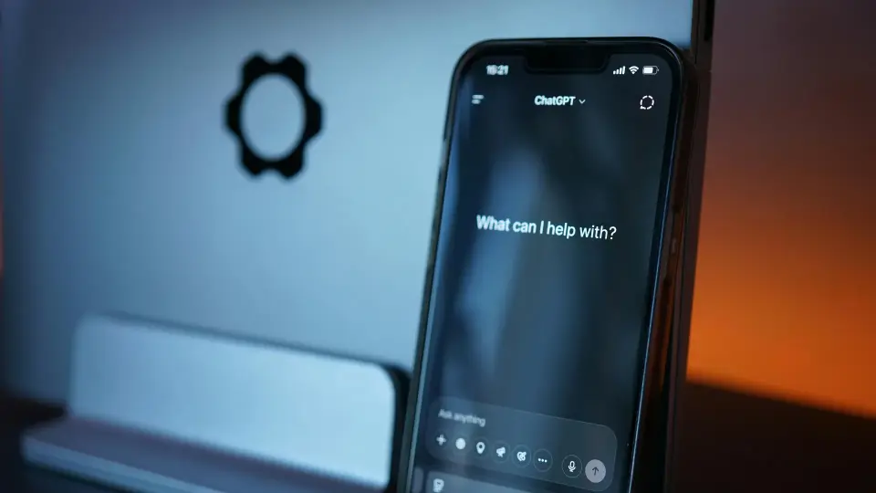 ChatGPT app open on a phone asking What can I help with?