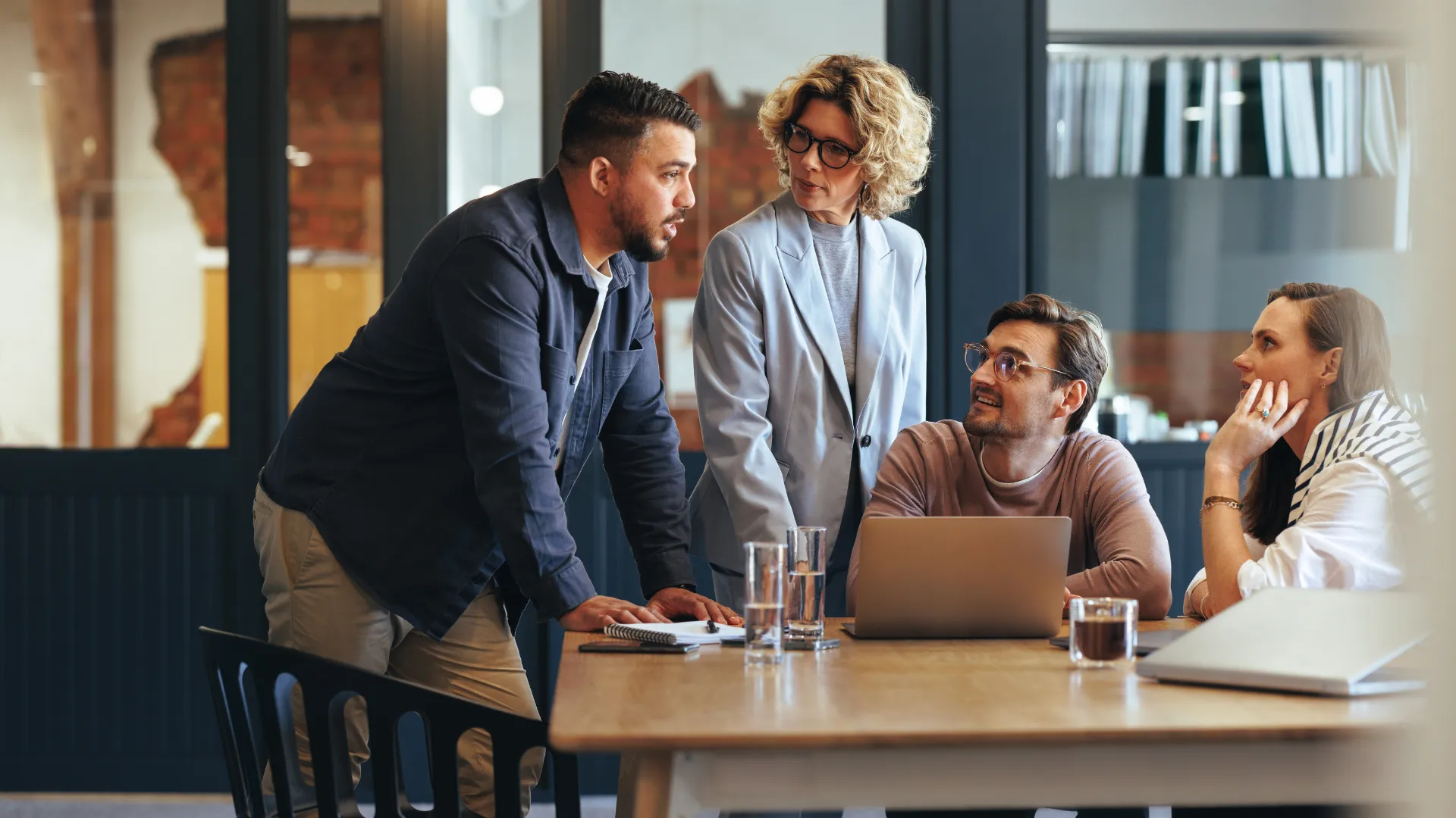 A project team reviews a commercial plan around a conference table