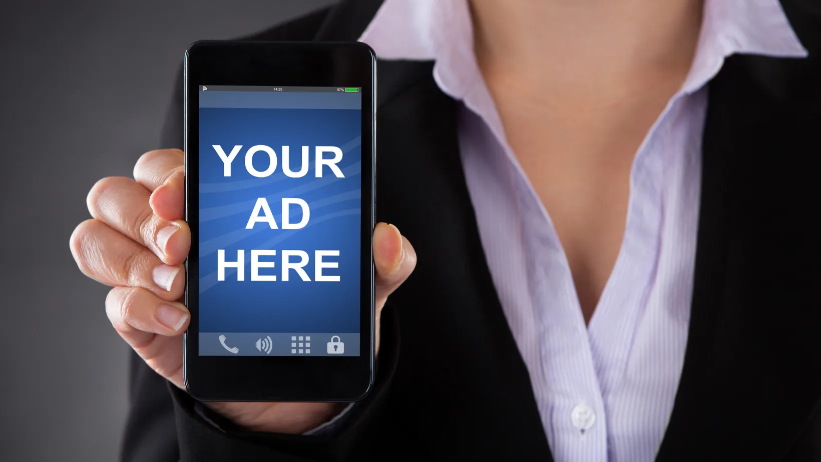 Hand holding a smartphone with a screen that reads Your Ad Here
