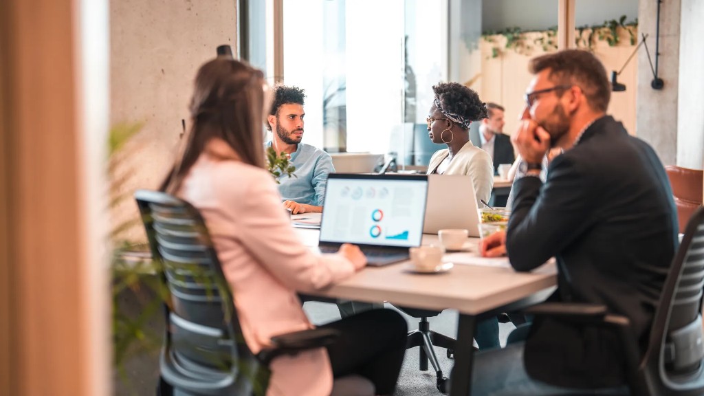 Marketing team reviewing campaign charts around a conference table