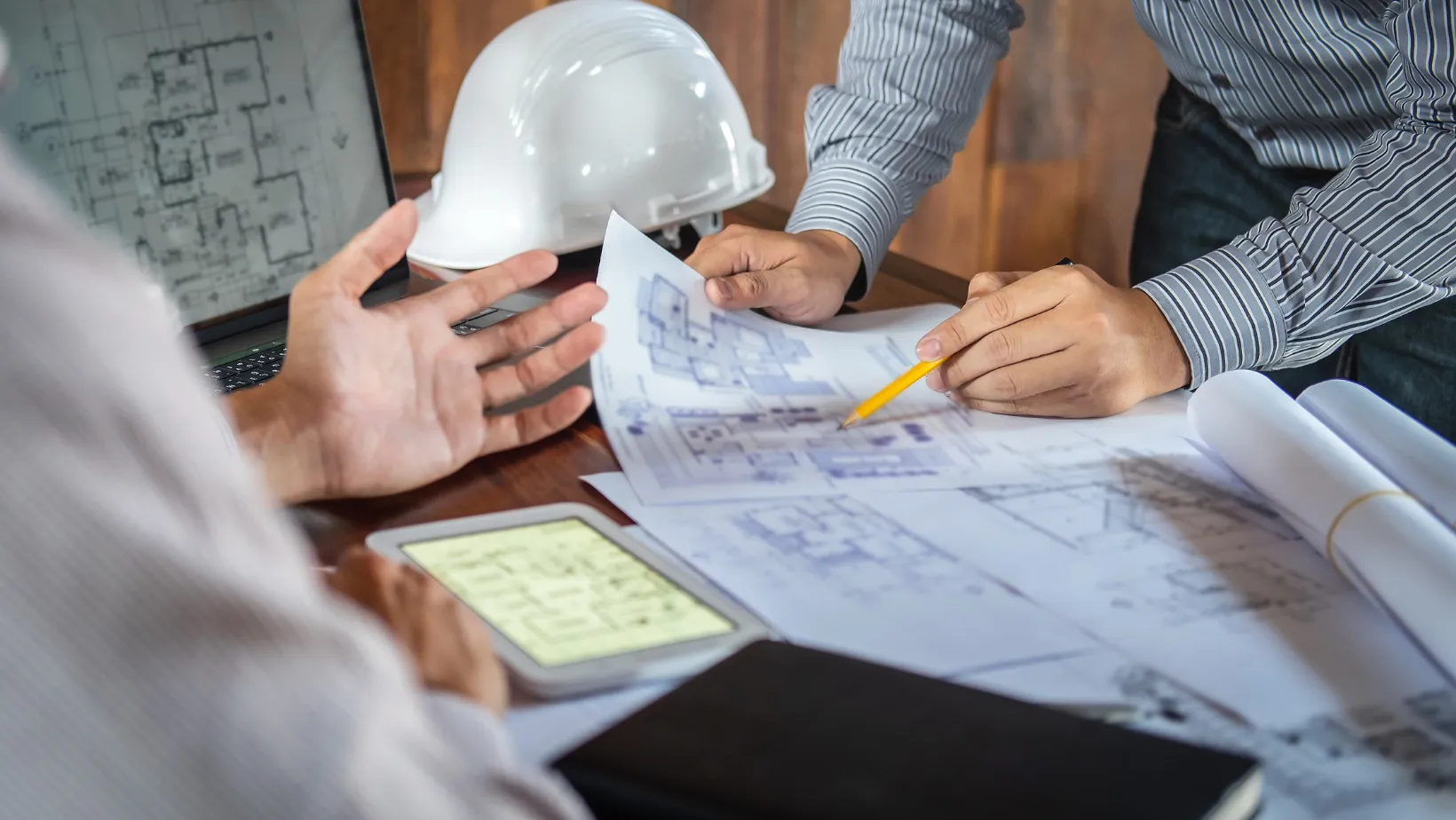 Contractors reviewing architectural floor plans