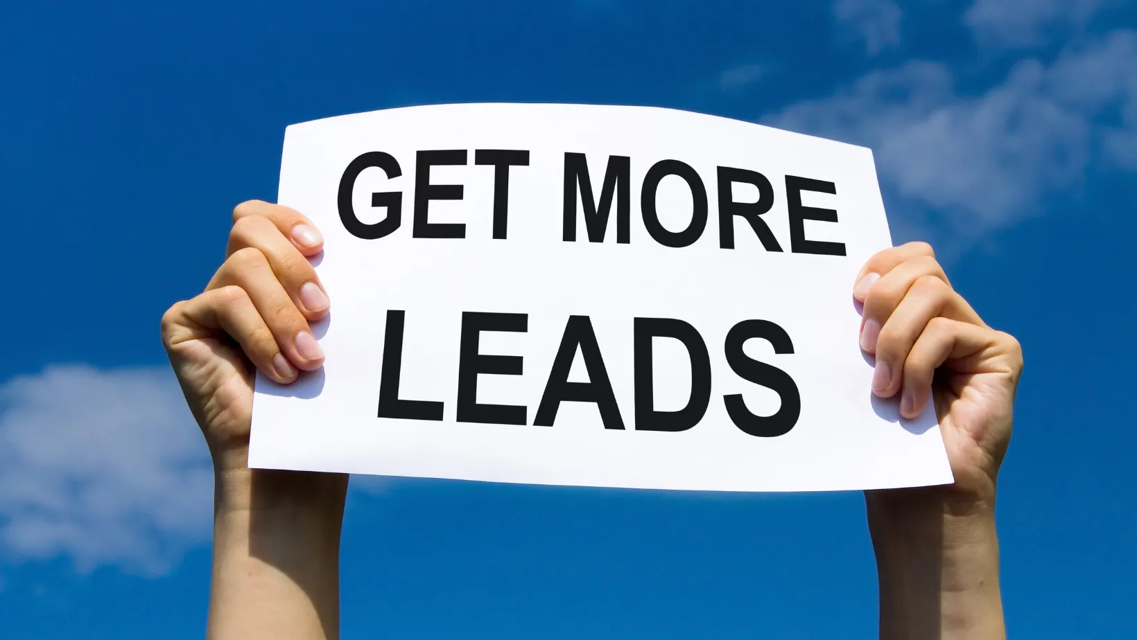 Hands holding a sign that reads Get More Leads