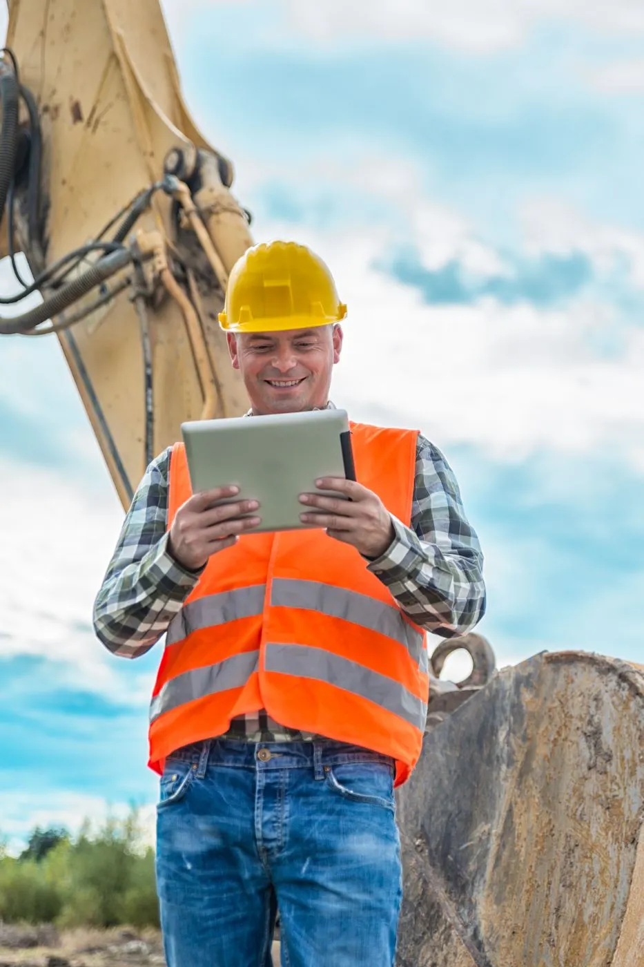A happy renovation contractor smiles while looking at his Apple tablet screen where he sees another quality remodeling lead that LeadGulls contractor marketing services team generated for him on Google Ads. 