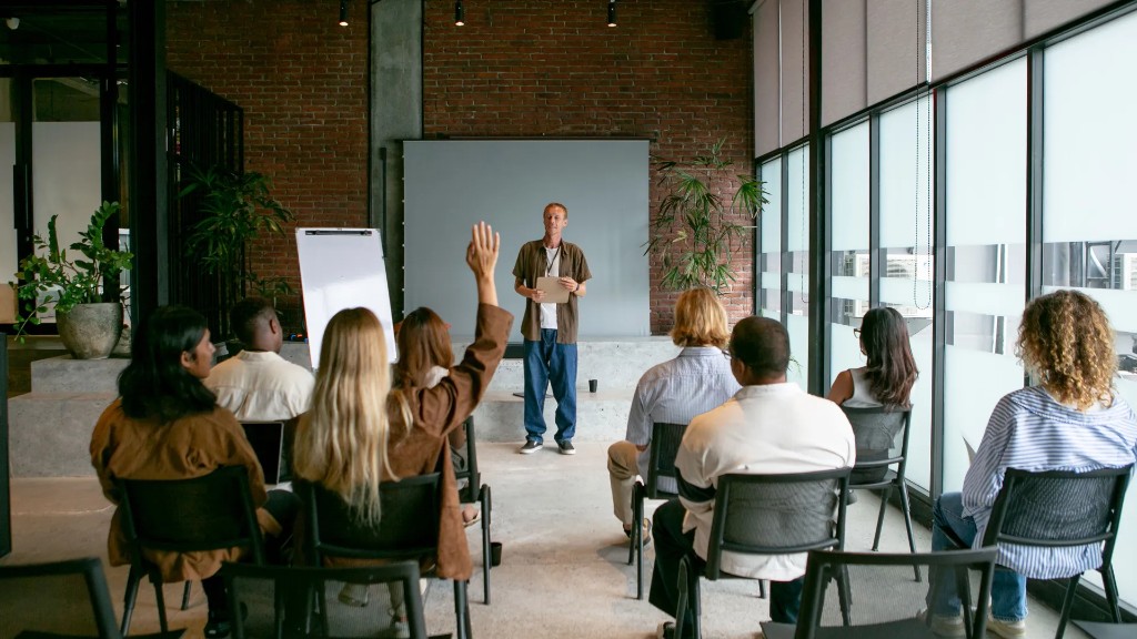 Small workshop with a presenter and a seated group in a bright meeting room