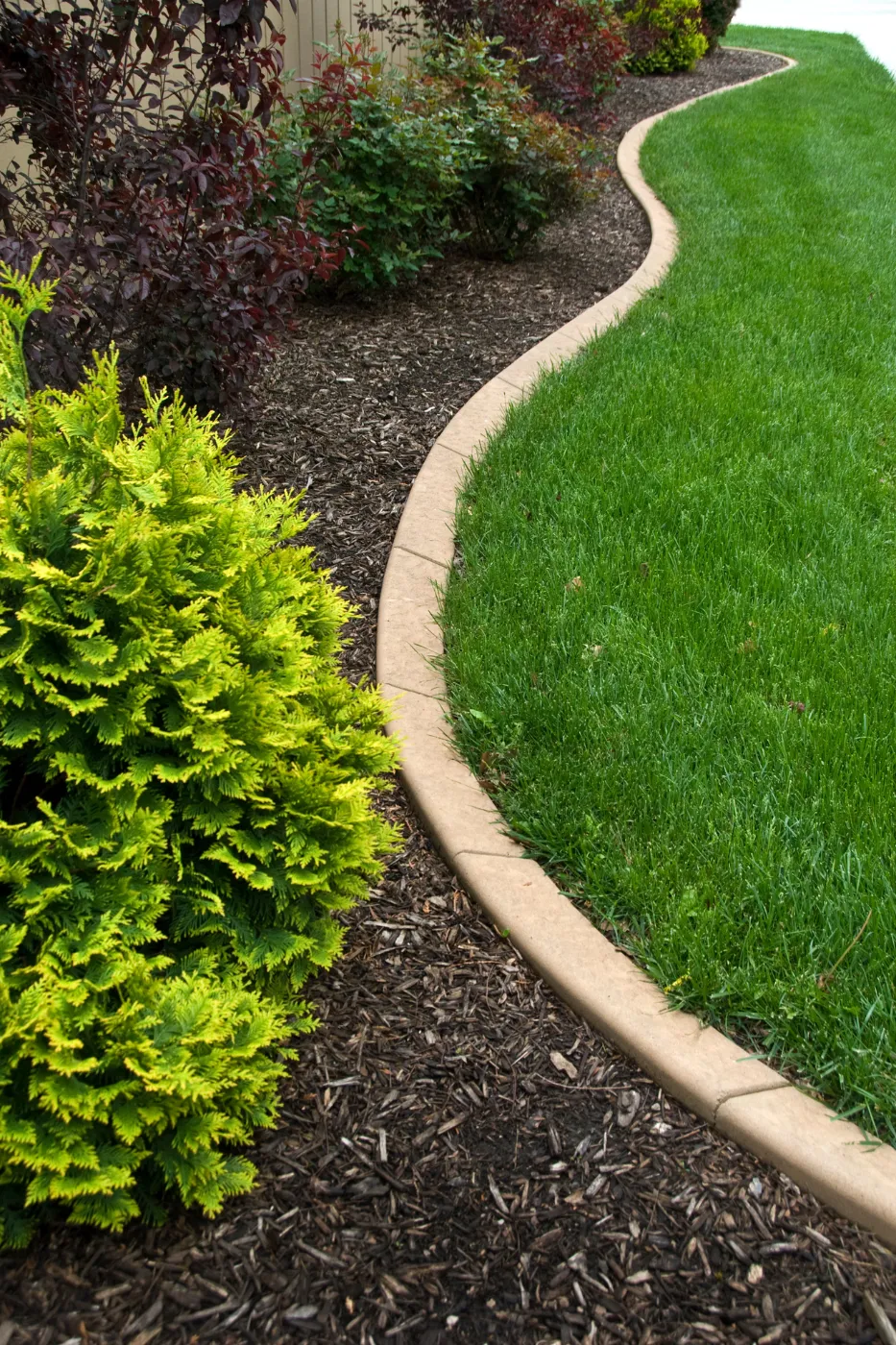 Landscaping crew working on a residential yard during peak season, representing qualified leads from digital marketing for landscapers.