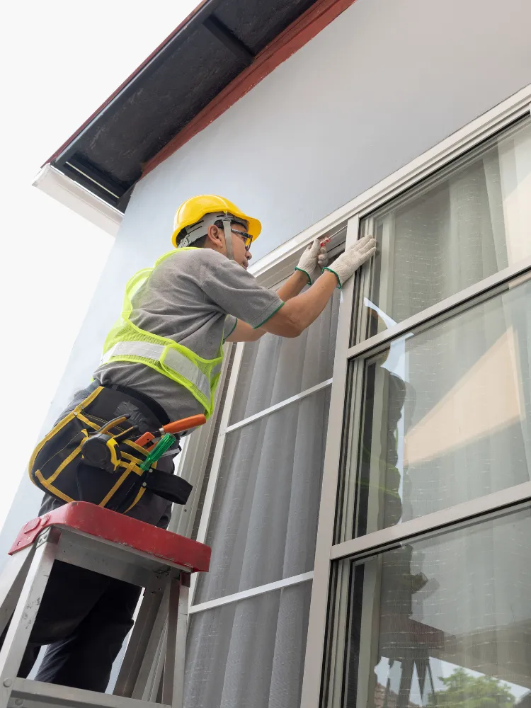 Window and door installation team reviewing a residential replacement project