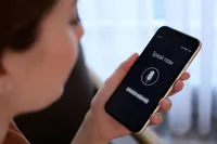 A woman speaks into a phone that says Speak now