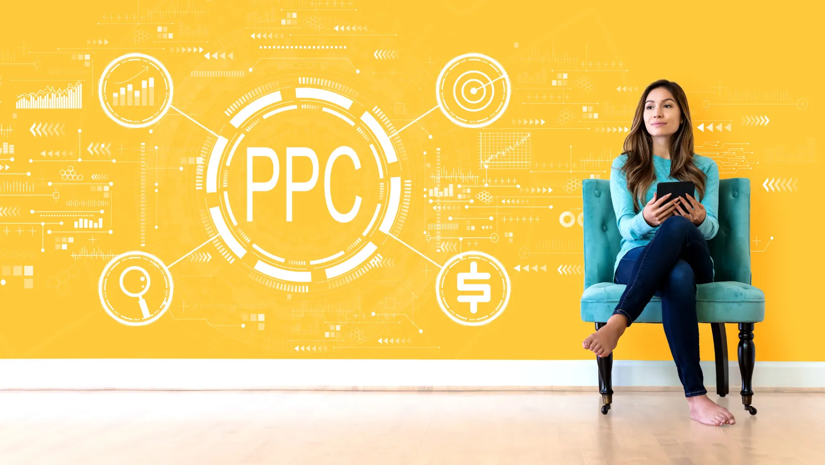 Woman with a tablet sitting in front of a yellow PPC strategy wall with analytics, targeting and budget icons