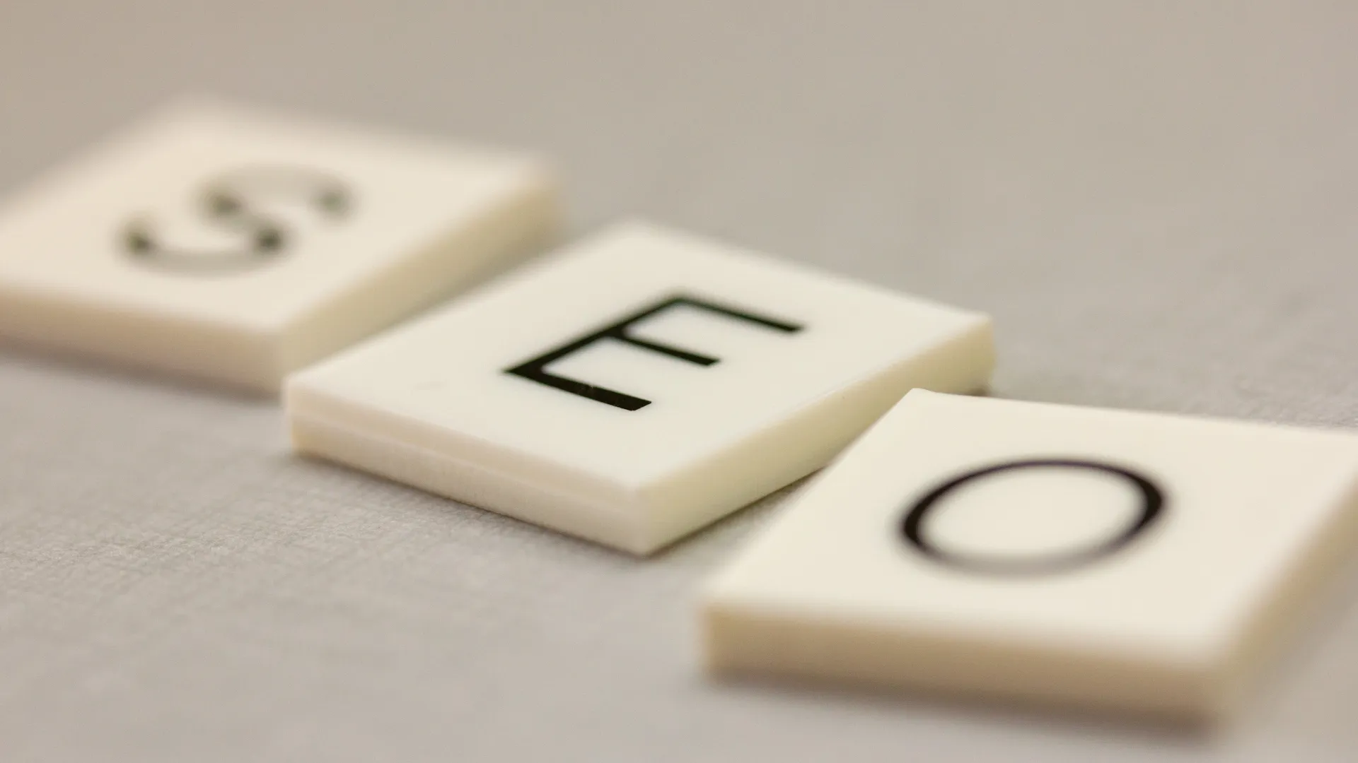 Letter tiles spelling SEO on a table