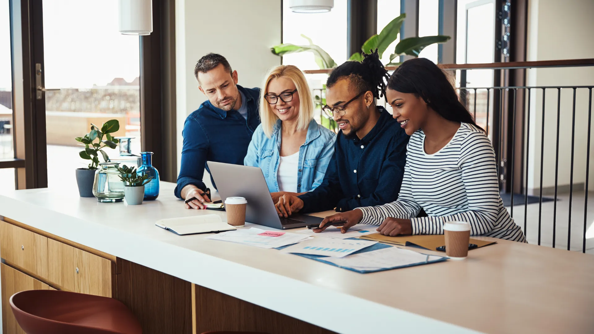 Marketing team reviewing roofing campaign results on a laptop