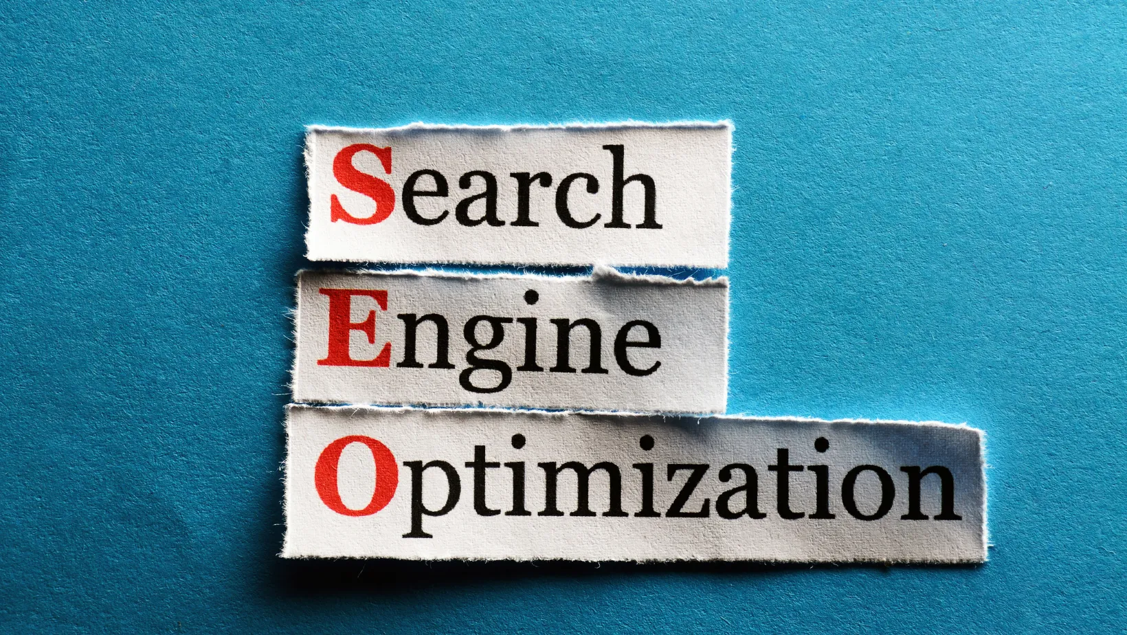 Torn paper strips spelling Search Engine Optimization