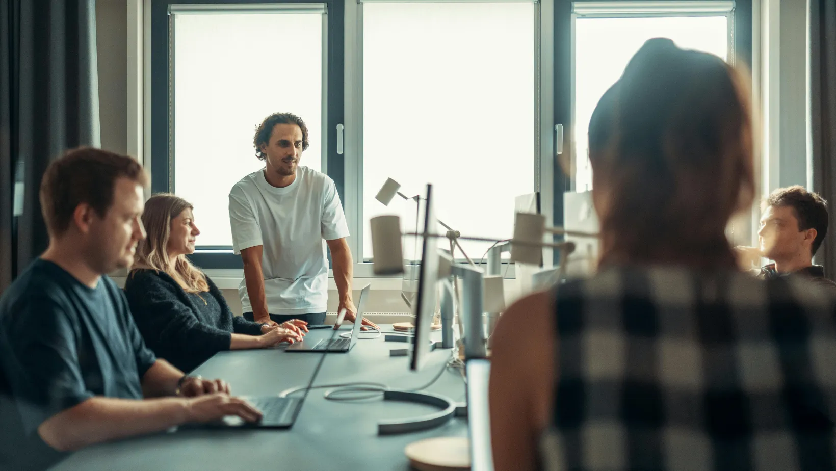 A marketing team meeting around a conference table