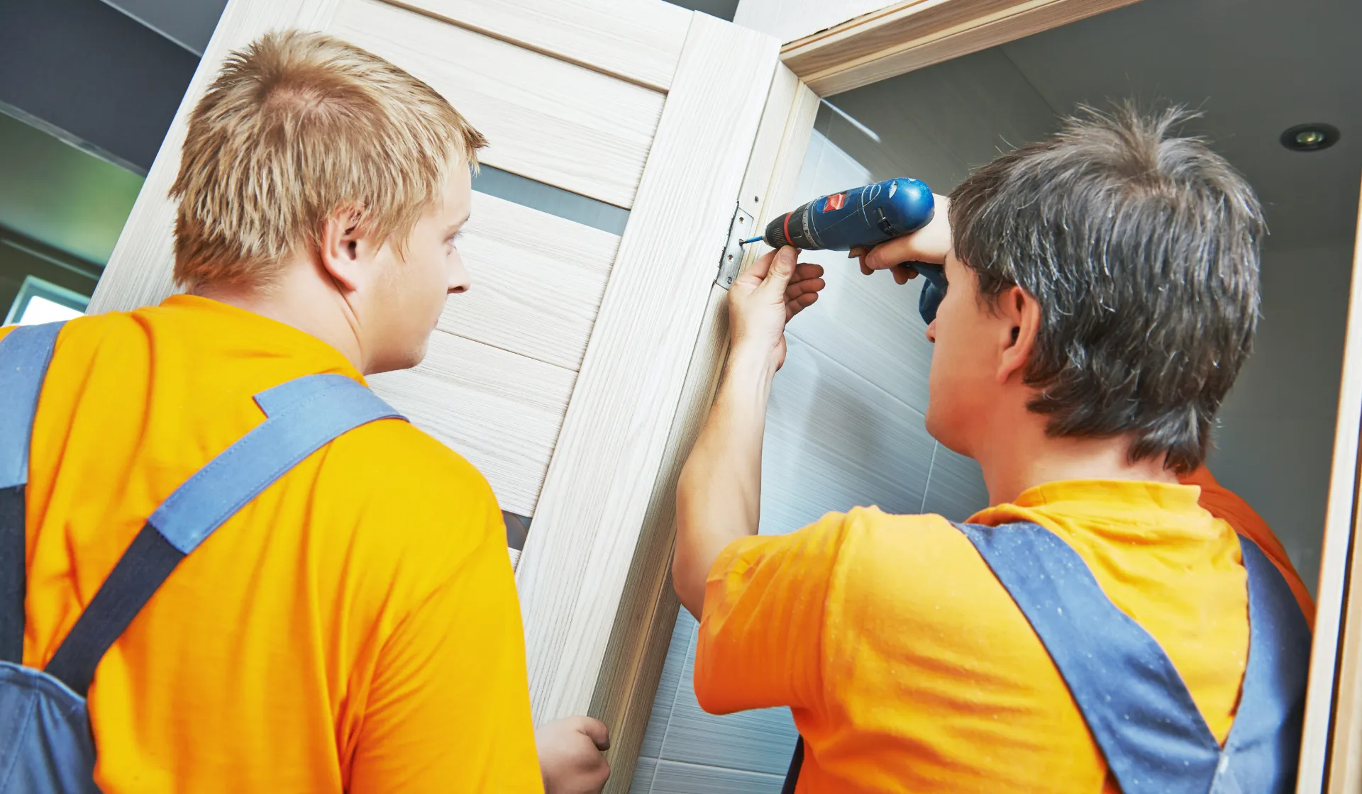 Two installers installing a door for a home